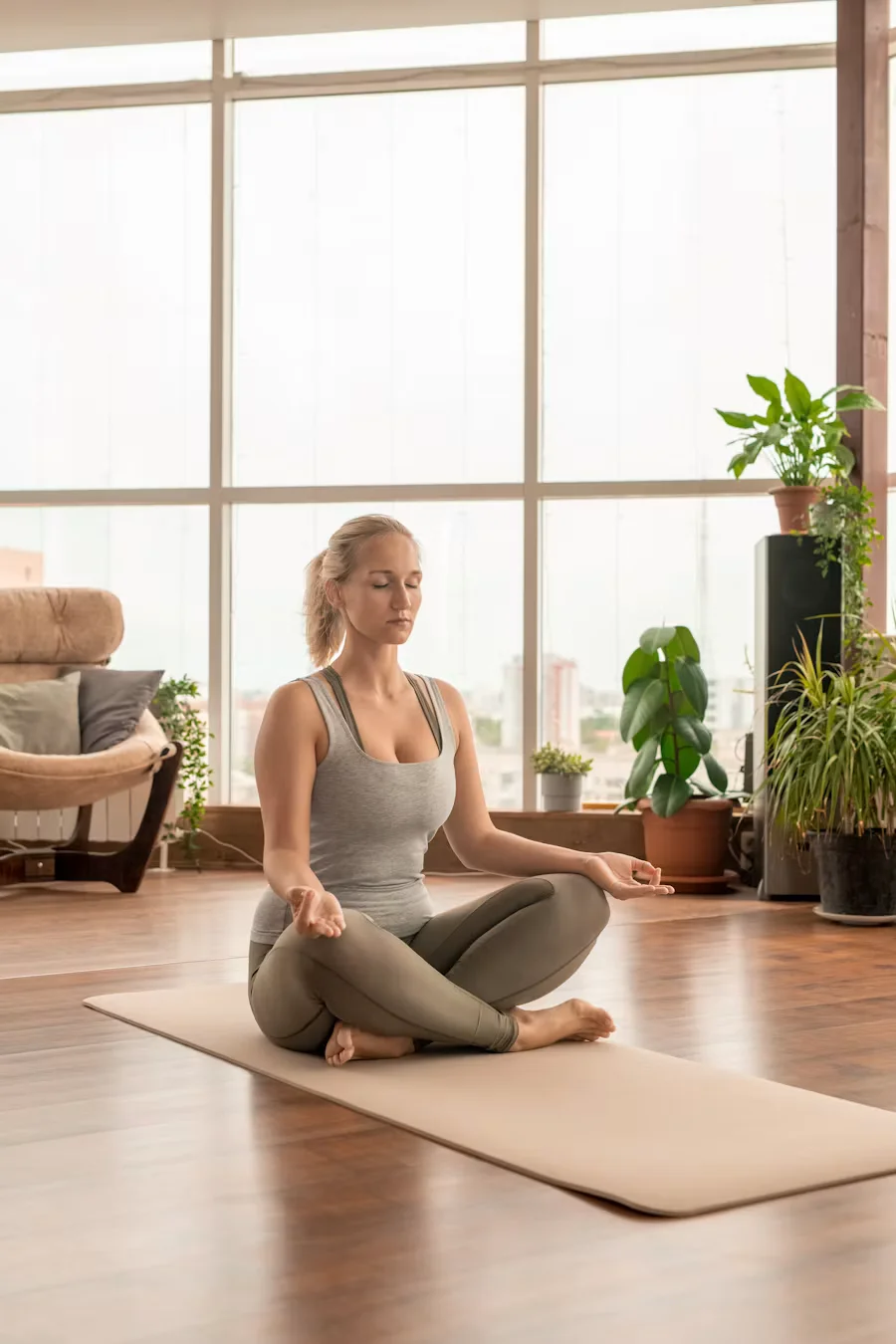 Smiling athletic woman in a sunlit room